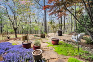 Enjoy the serene setting of the landscape and private forested acre lot.