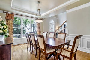 Beautiful dining room with wainscoting, tray ceiling and tripple-window!