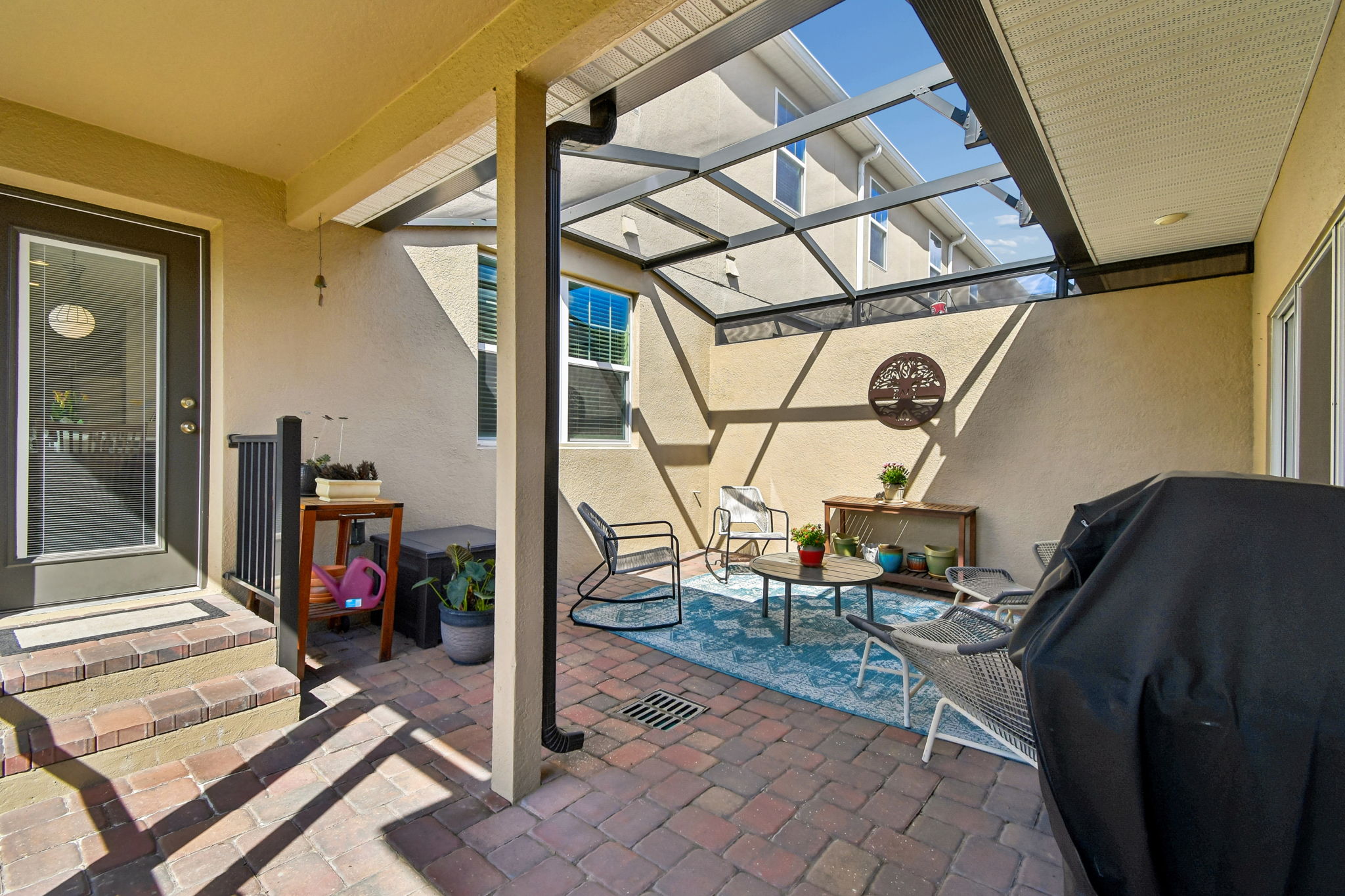 Patio has drain and trap door for dryer vent access