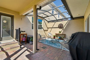 Patio has drain and trap door for dryer vent access