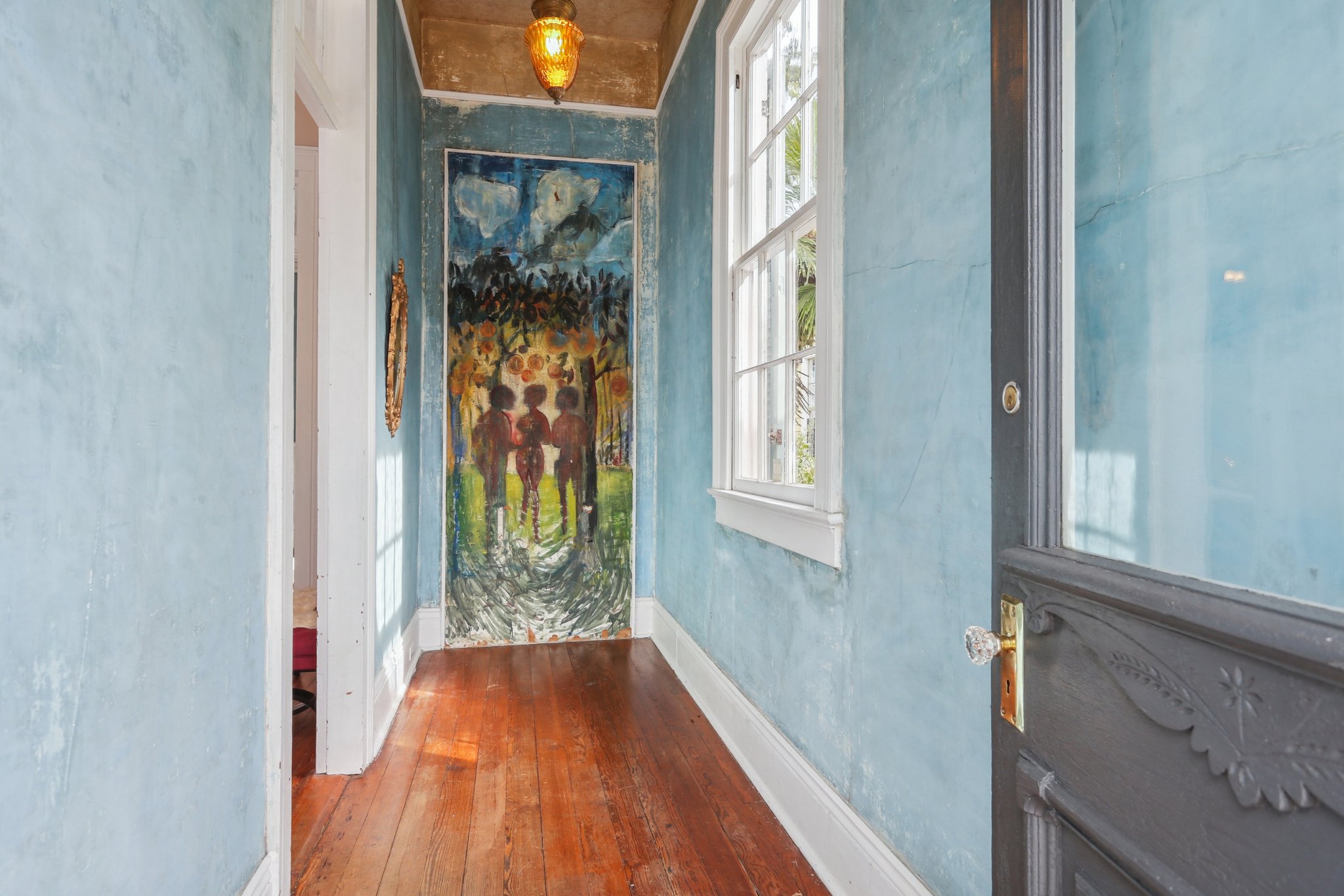 Entry foyer features wall mural by New Orleans-based artist Haroumi