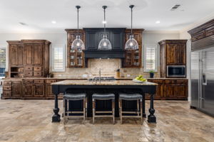 Open concept chef's kitchen with large entertaining island and Wolf and Sub-Zero appliances