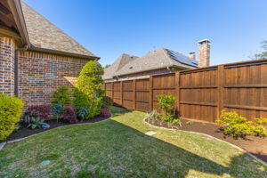 Grassy area adjacent to outdoor kitchen