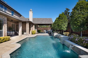 Resort-style pool, outdoor living and dining areas and outdoor kitchen