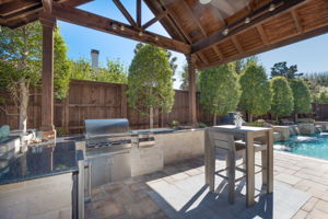 Outdoor chef's kitchen with seating area