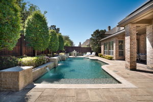 Backyard oasis and resort-style pool with tasteful landscaping and lounge area