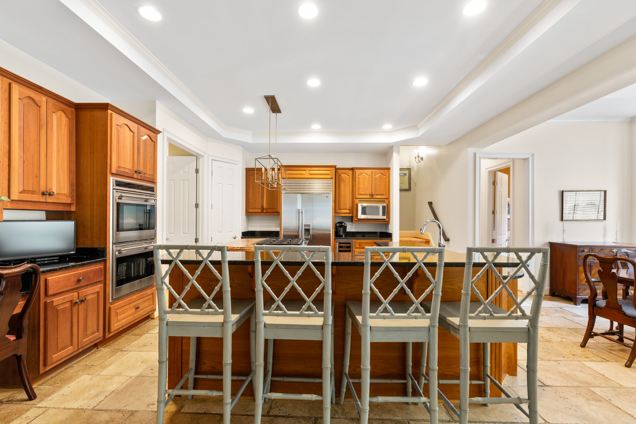 Large chef's kitchen with raised bar eat in counters and granite tops.
