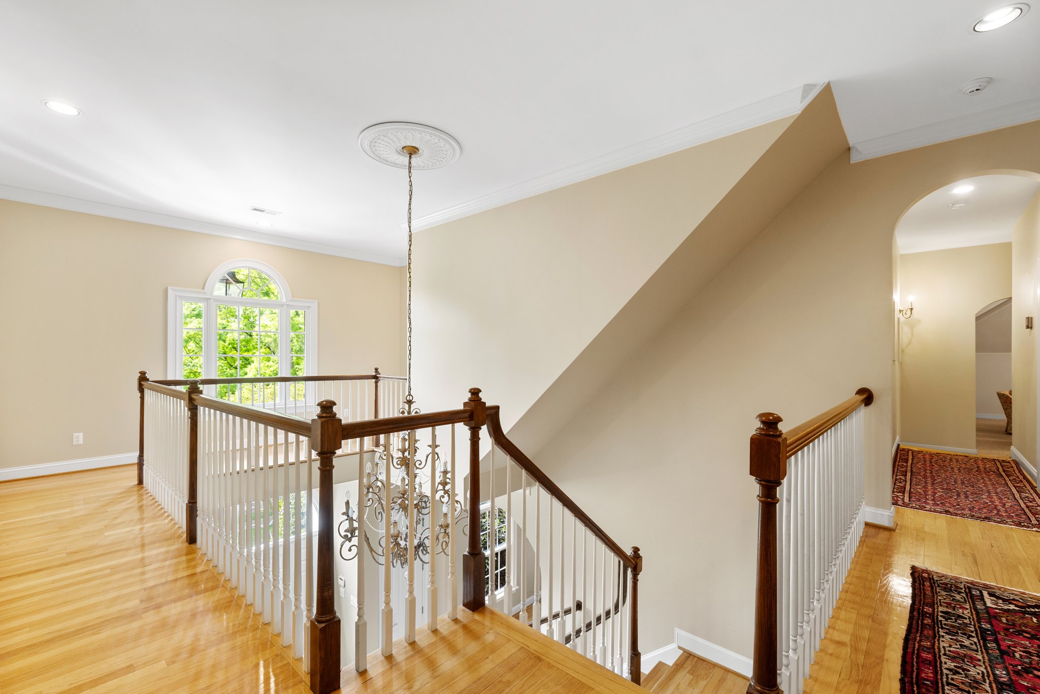 2nd floor landing has hardwood floors, palladian window, and walk up attic access.