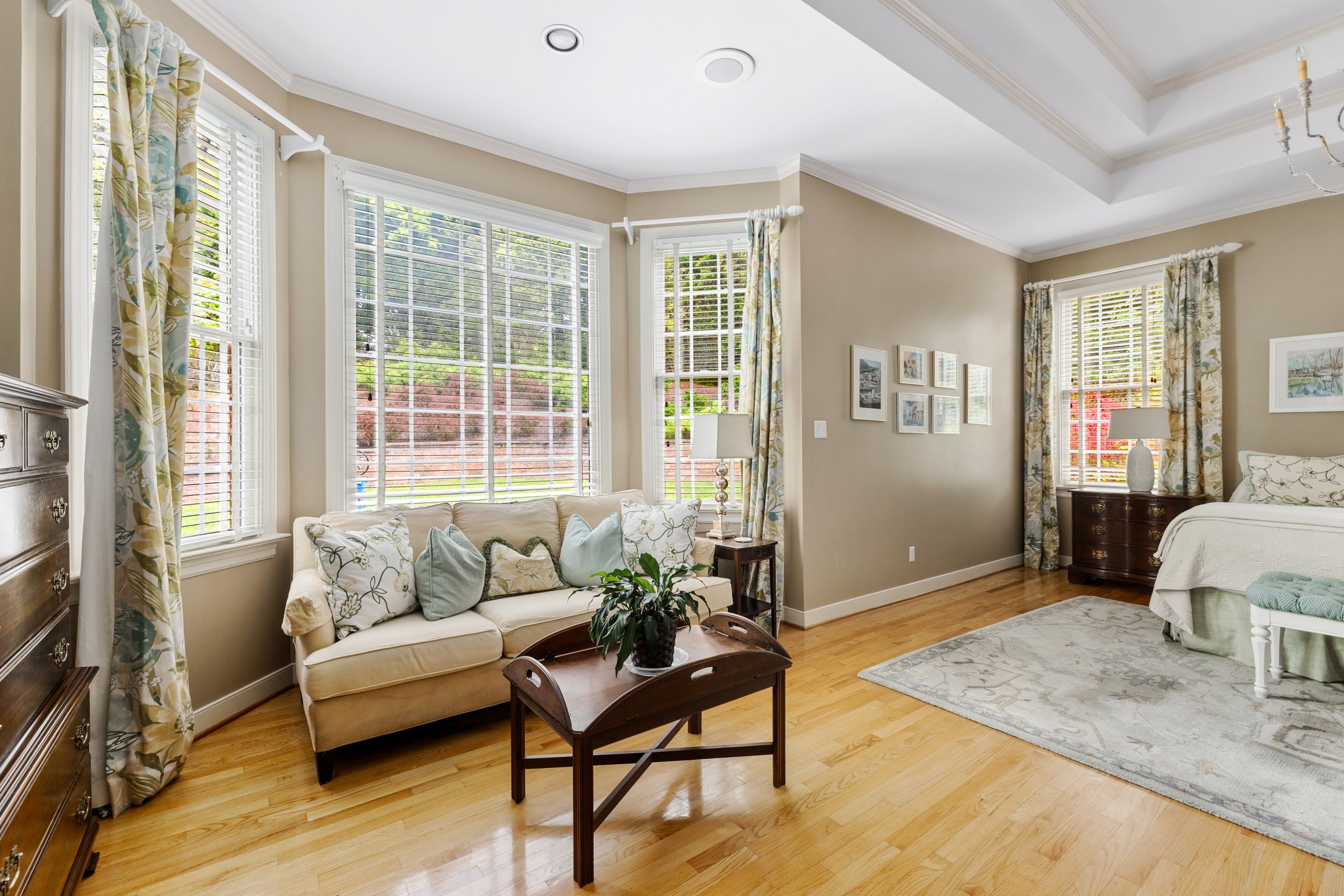 The primary bedroom has a beautiful bay window and opens to the sunroom.