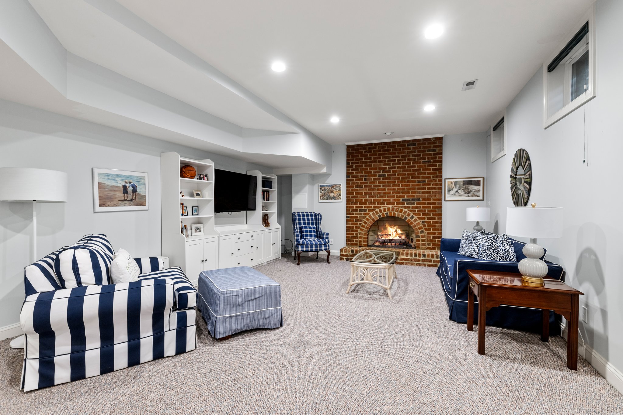 The lower level has huge space with a gas fireplace, built-ins, and hub and wiring for surround sound speakers.