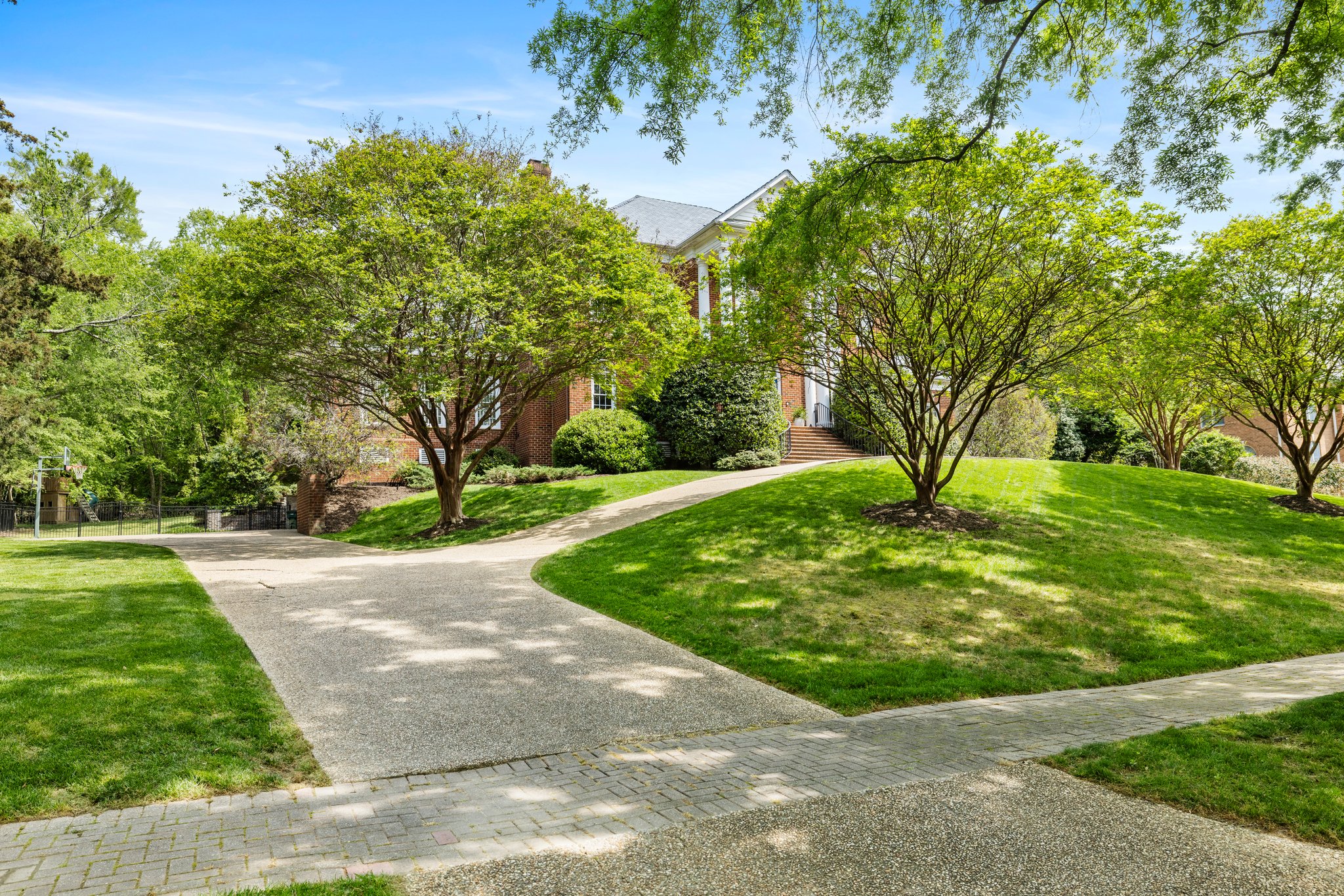 Circular aggregate driveway with large side driveway access to the garage.