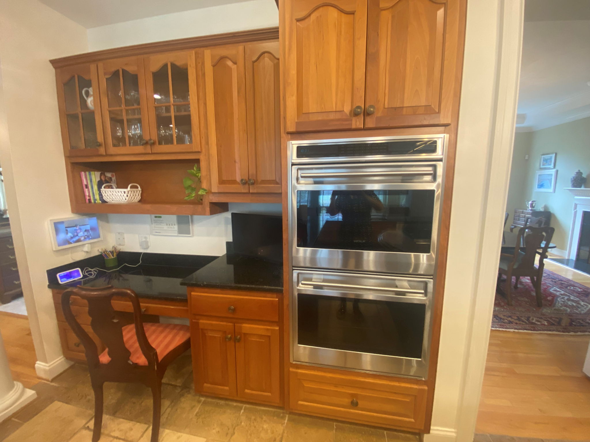 Built in desk with intercom system and double wall ovens one of which is a convection oven.