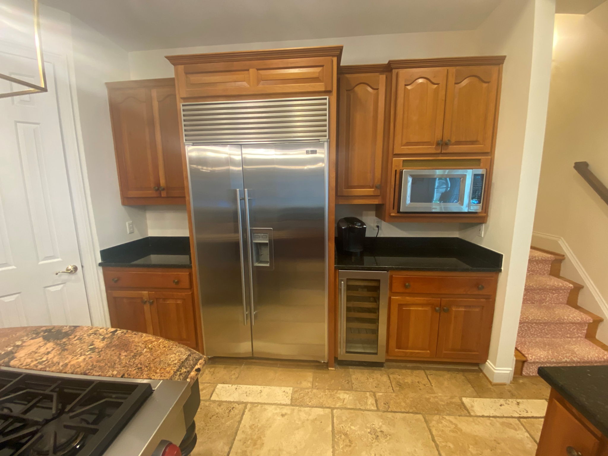 Sub-Zero refrigerator, Sub-Zero wine refrigerator, and built in microwave.