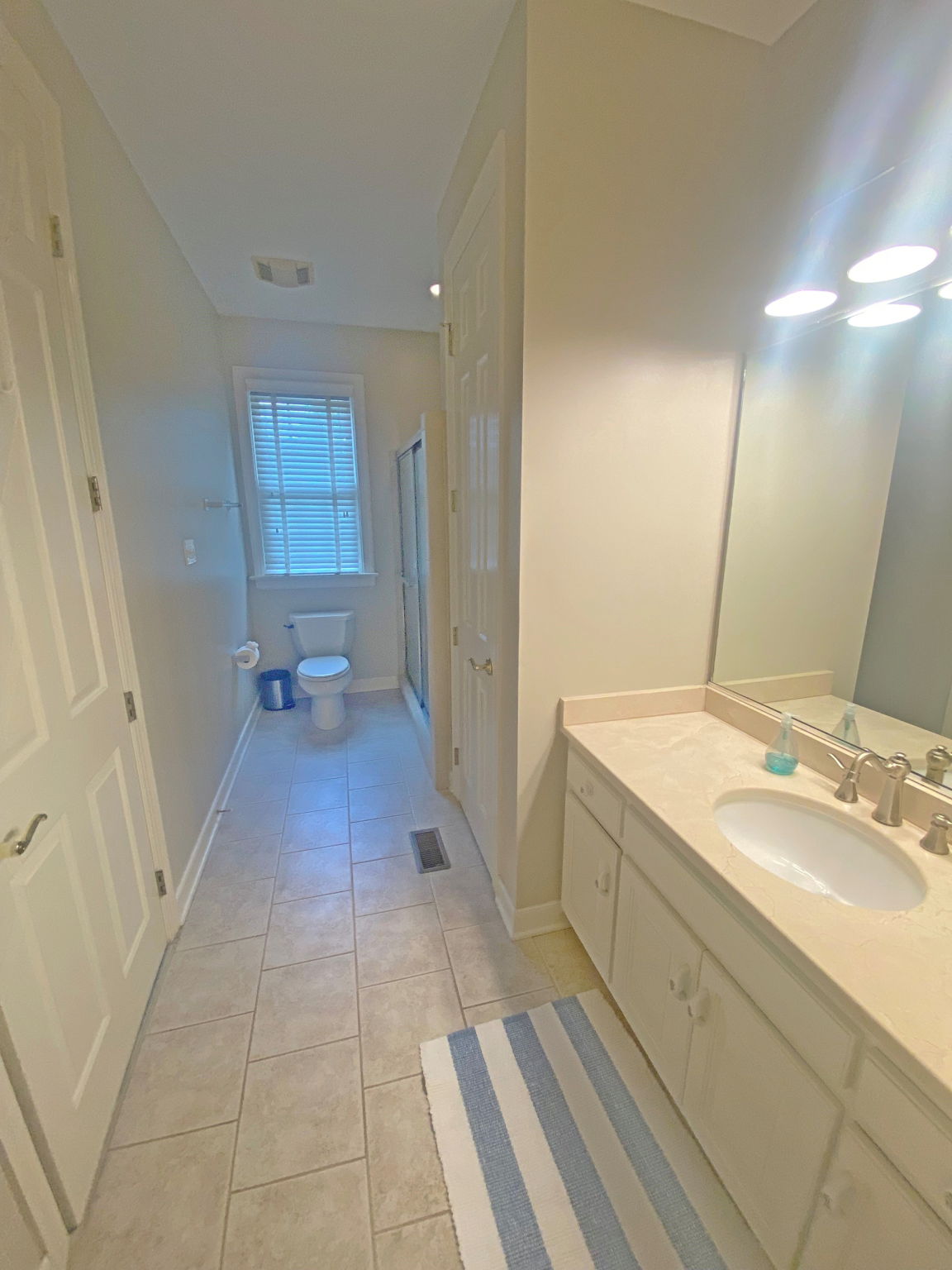 Large bath with linen closet and large adjacent walk in closet.