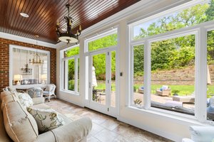Spacious sun room with recessed lighting.