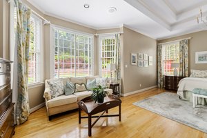 The primary bedroom has a beautiful bay window and opens to the sunroom.
