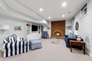 The lower level has huge space with a gas fireplace, built-ins, and hub and wiring for surround sound speakers.