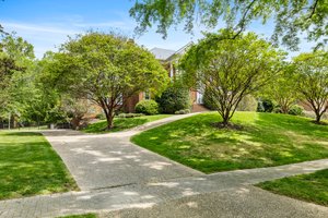 Circular aggregate driveway with large side driveway access to the garage.