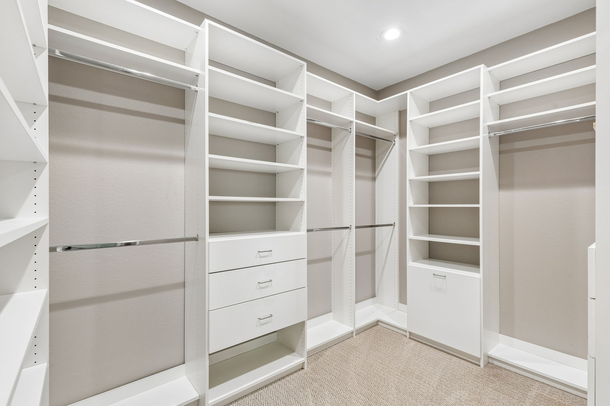 The primary suite’s custom Closets by Design system offers extensive hanging space, shelving and built-in drawer storage.