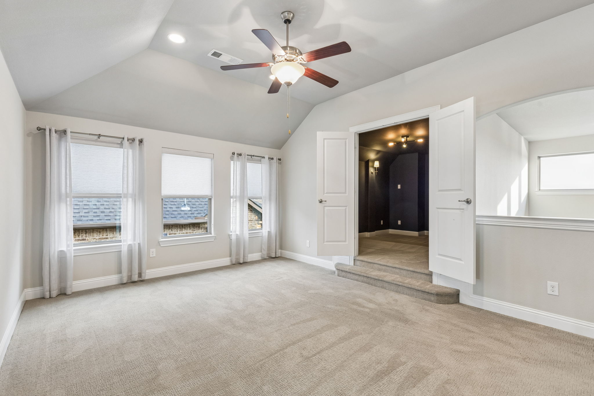 The spacious upstairs game room provides a versatile second living area with direct access to french door media room.