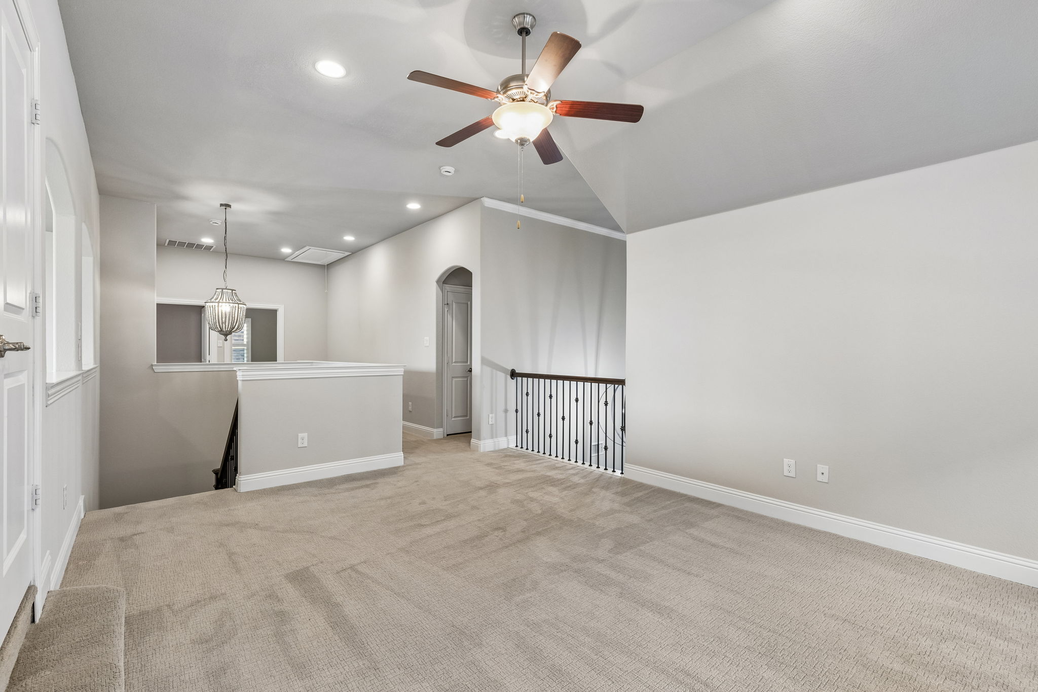 The expansive second-floor game room provides an additional living space with a built-in desk and cabinetry for homework, gaming or hobbies.