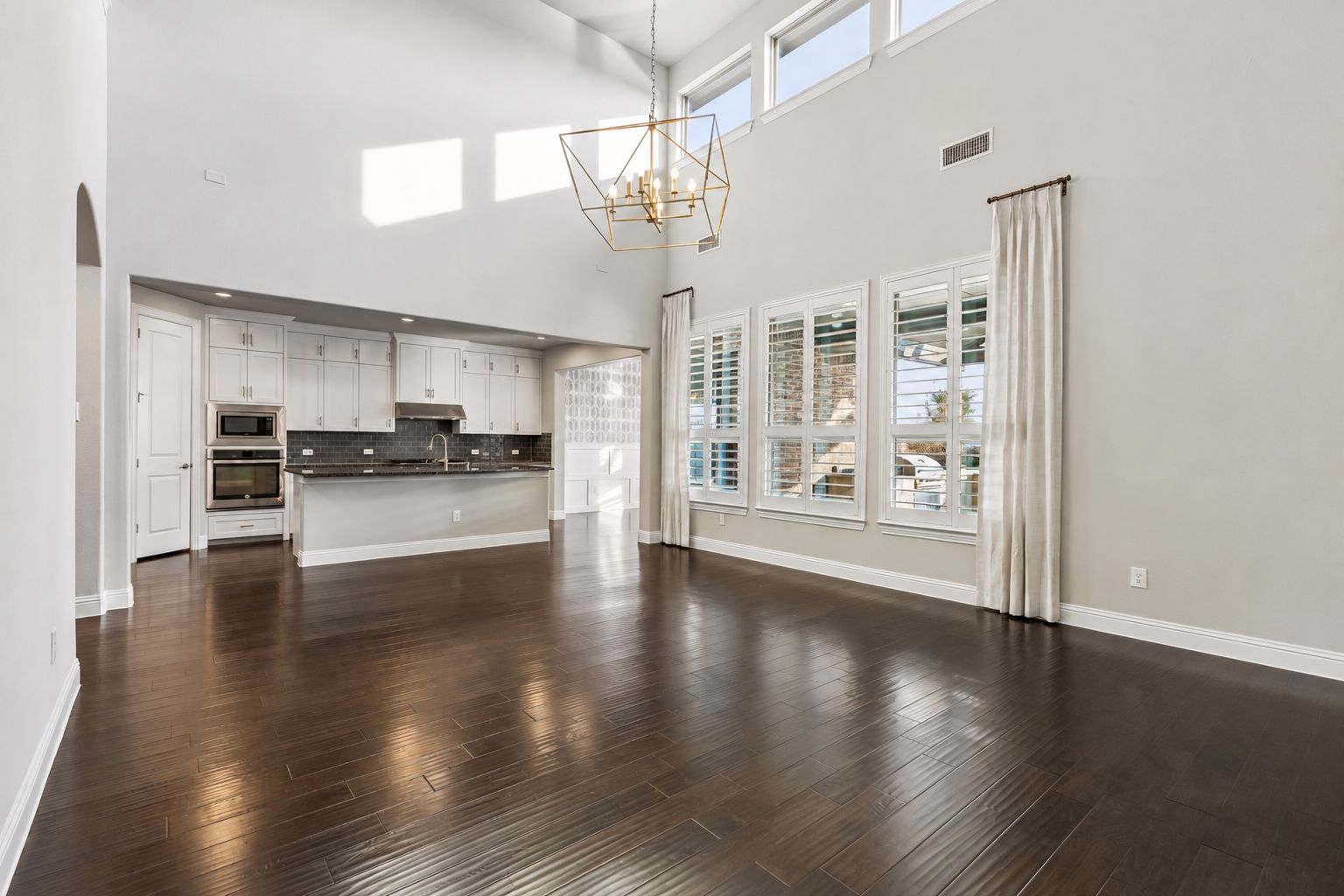 At the heart of the home, a wall of 2-story windows captures incredible Texas sunsets and fills the open-concept living space with natural light