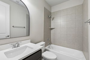 The first-floor guest bath is refreshed with a new 2026 quartz countertop and offers a full tub/shower combination.