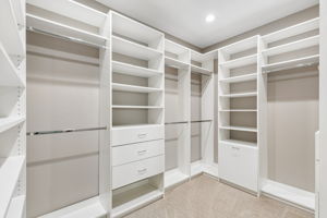 The primary suite’s custom Closets by Design system offers extensive hanging space, shelving and built-in drawer storage.