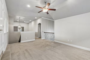 The expansive second-floor game room provides an additional living space with a built-in desk and cabinetry for homework, gaming or hobbies.