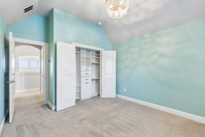 Upstairs bedroom features a custom Closets by Design system for elevated storage and organization.