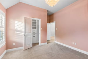 Upstairs bedroom features a custom Closets by Design system for elevated storage and organization.