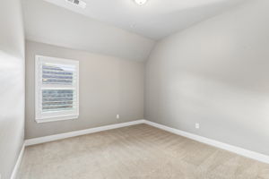 secondary bedroom features recently installed carpet, plantation shutters and a neutral palette ready for personalization.