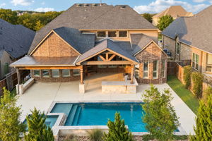 Thoughtfully designed layout with heated pool & spa, expansive covered living space, cedar pergola, granite entertaining bar and low-maintenance turf.