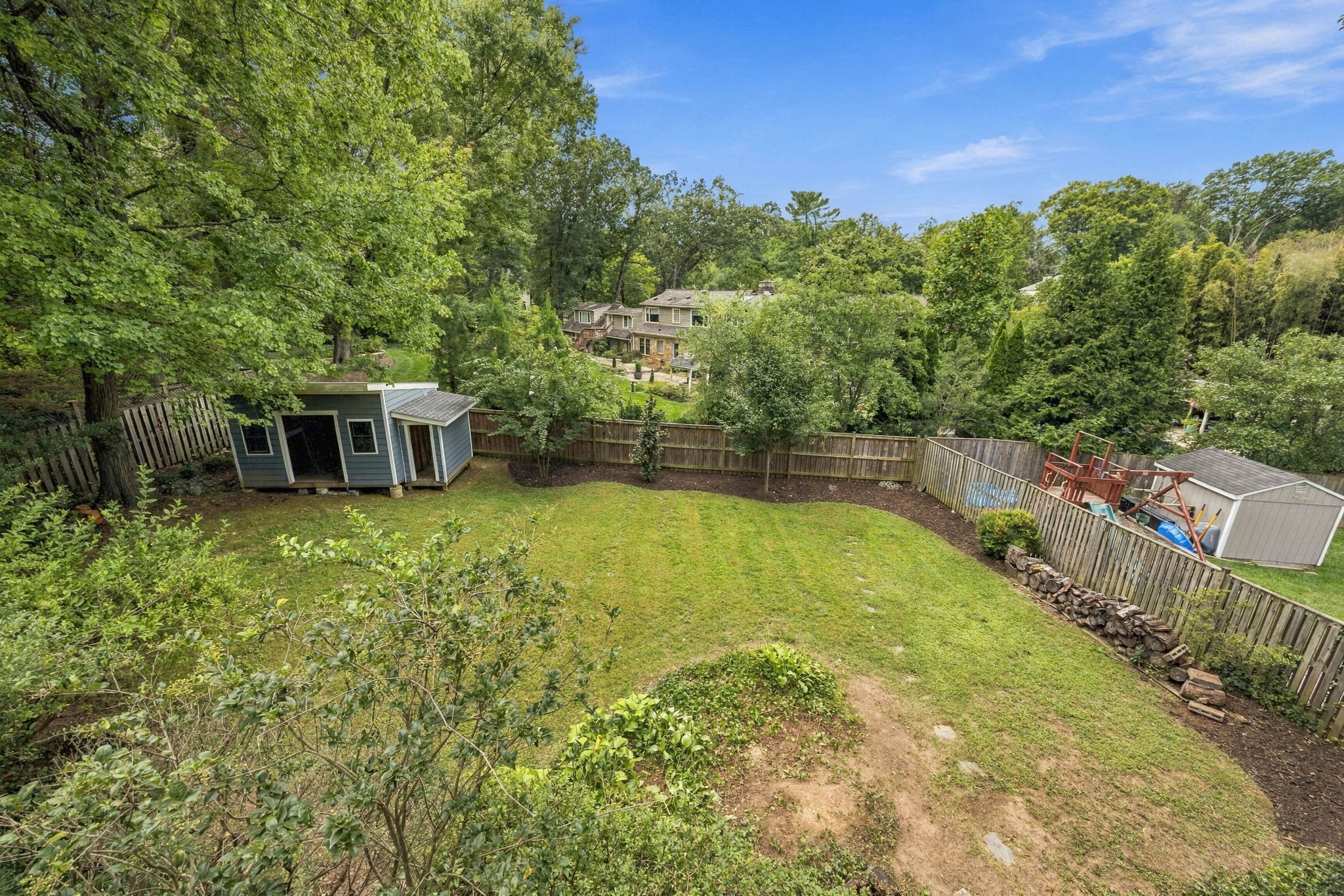 Flat back yard with large storage shed