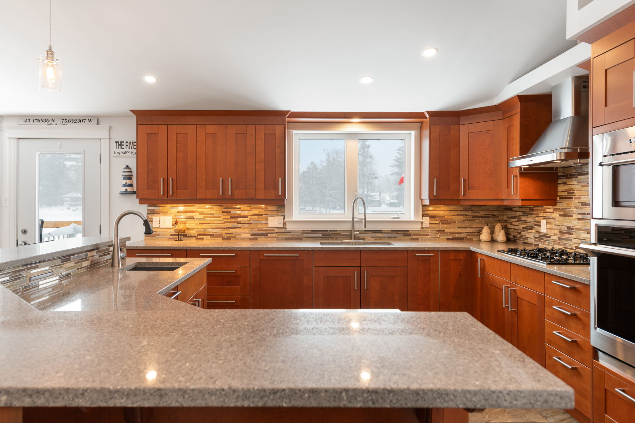 Chef's kitchen features plenty of counter and cupboard space and granite counters