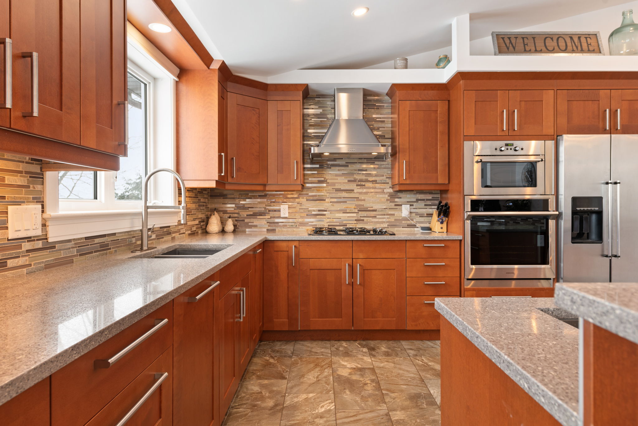 Chef's kitchen features plenty of counter and cupboard space and granite counters