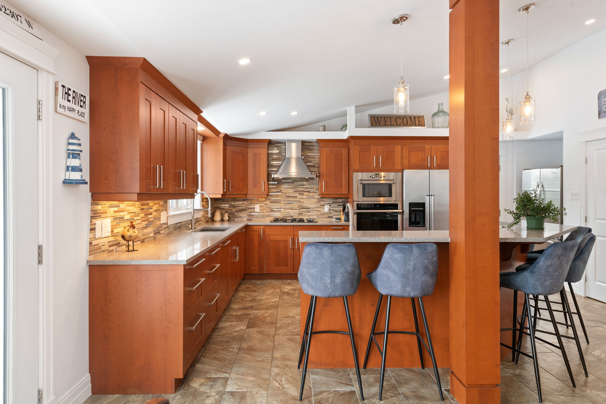 Chef's kitchen featuring stainless steel appliances, 6-seat breakfast bar and granite countertop