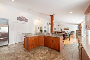 Chef's kitchen features plenty of counter and cupboard space and granite counters