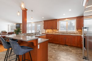 Chef's kitchen features plenty of counter and cupboard space and granite counters