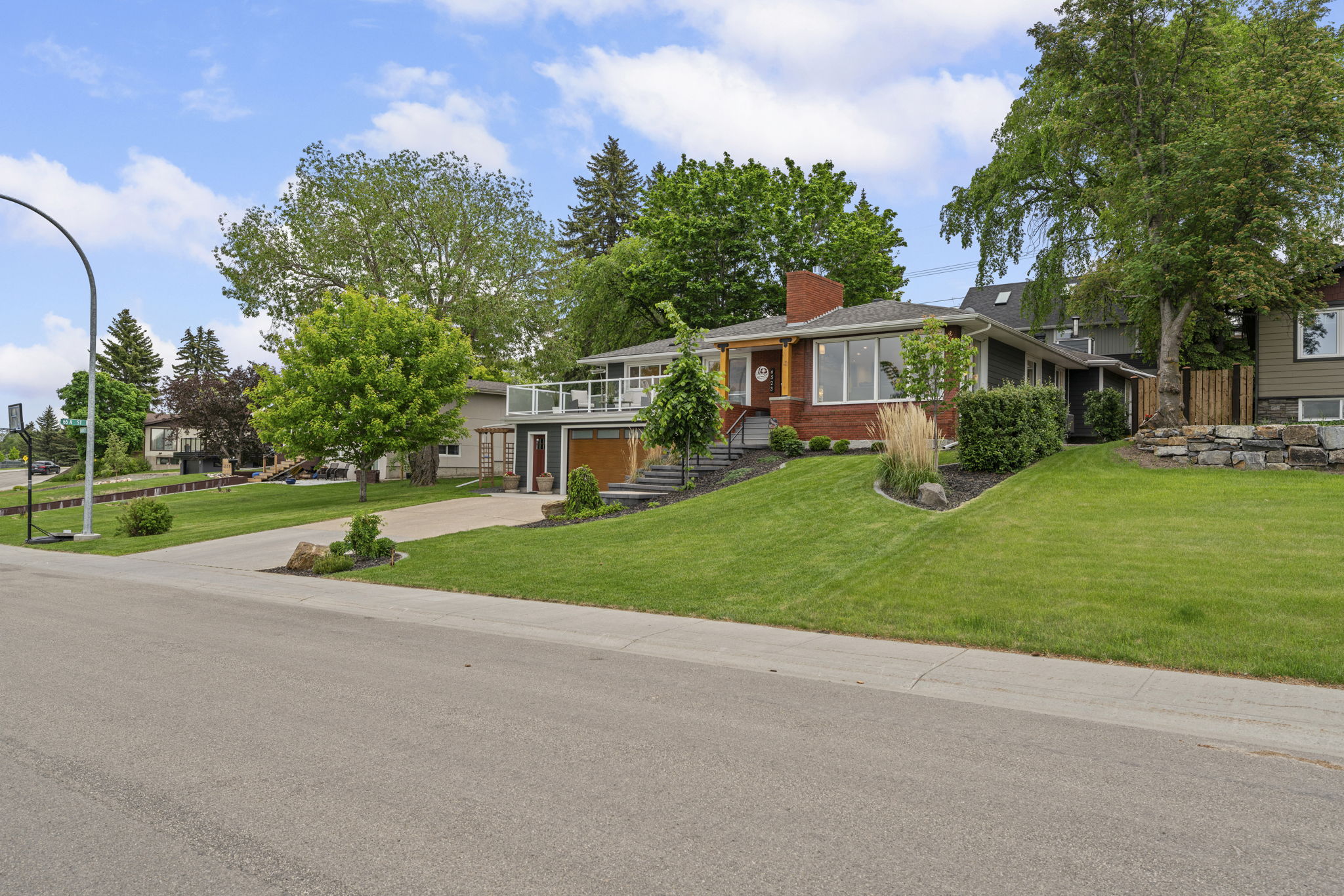 Street-side view of the Hardisty Drive home and its broad front lawn.