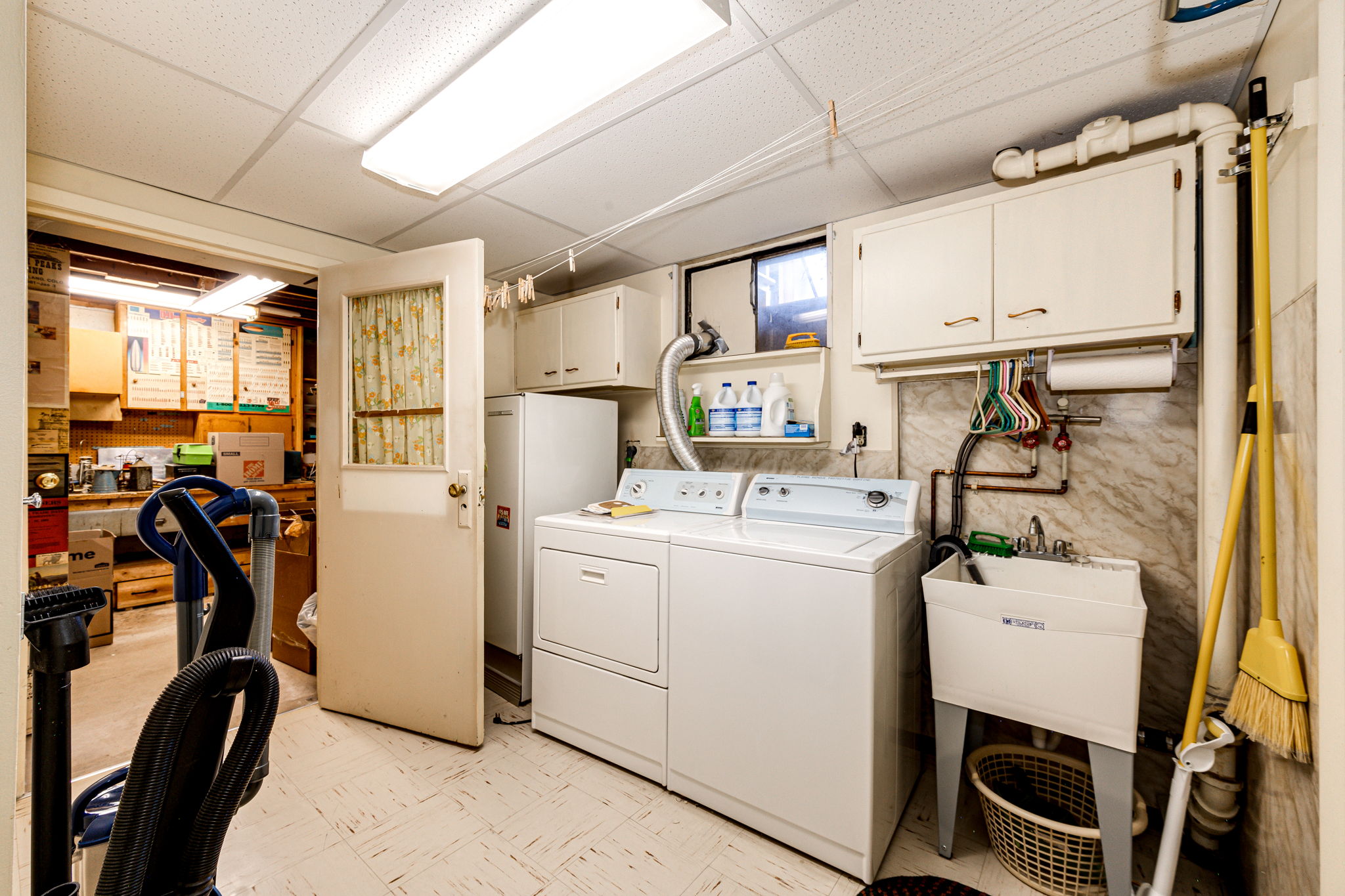 Laundry area in the basement with a utility sink