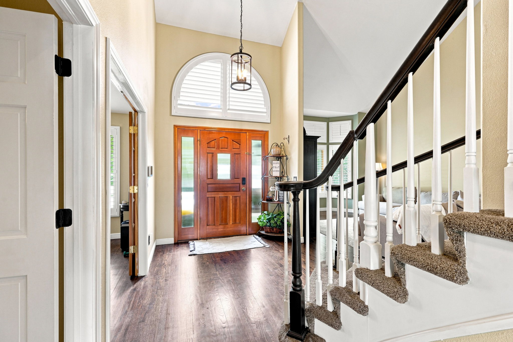 Step inside to an open bright and welcoming floorplan.  Entrance  leads to the office, stairs to second floor, formal living room, new foyer lighting, plantation shutters, hardwood flooring throughout main floor.