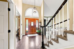 Step inside to an open bright and welcoming floorplan.  Entrance  leads to the office, stairs to second floor, formal living room, new foyer lighting, plantation shutters, hardwood flooring throughout main floor.