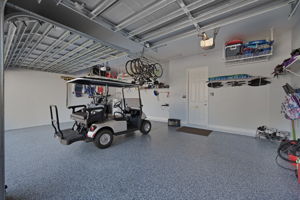 Garage with storage and an epoxied garage floor.