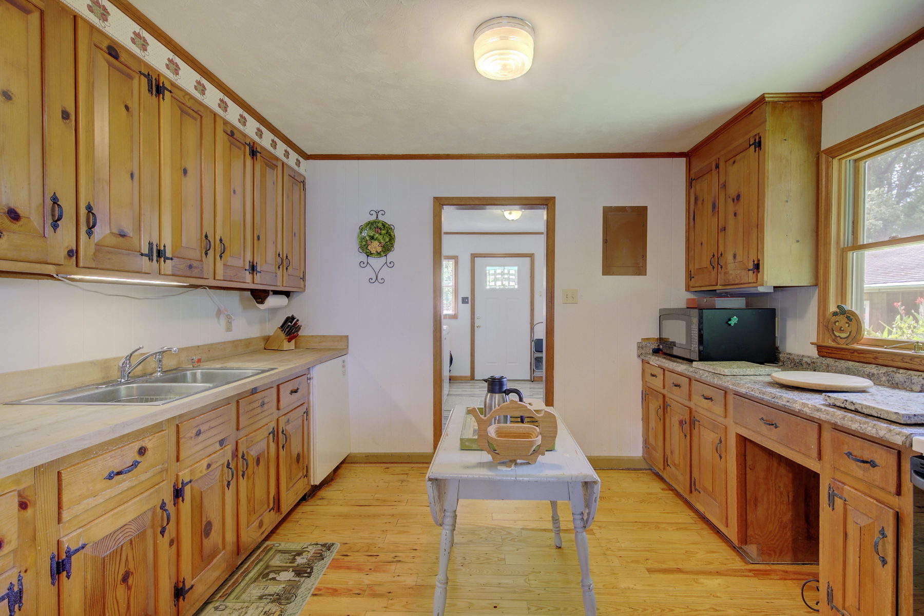 Original Knotty Pine cabinets and Hardwood floors in Kitchen