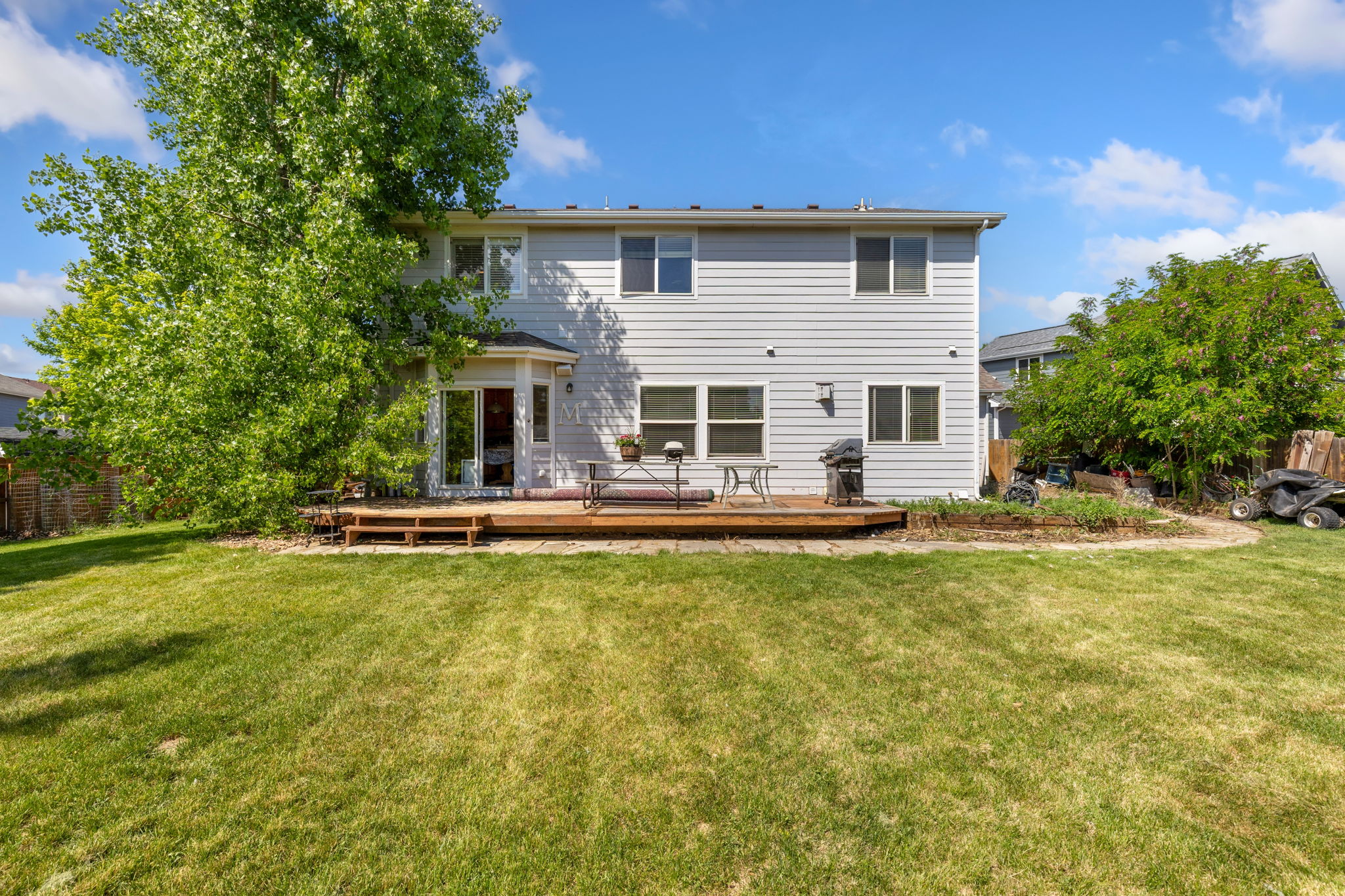 Huge yard, large deck, another large tree providing amazing shade