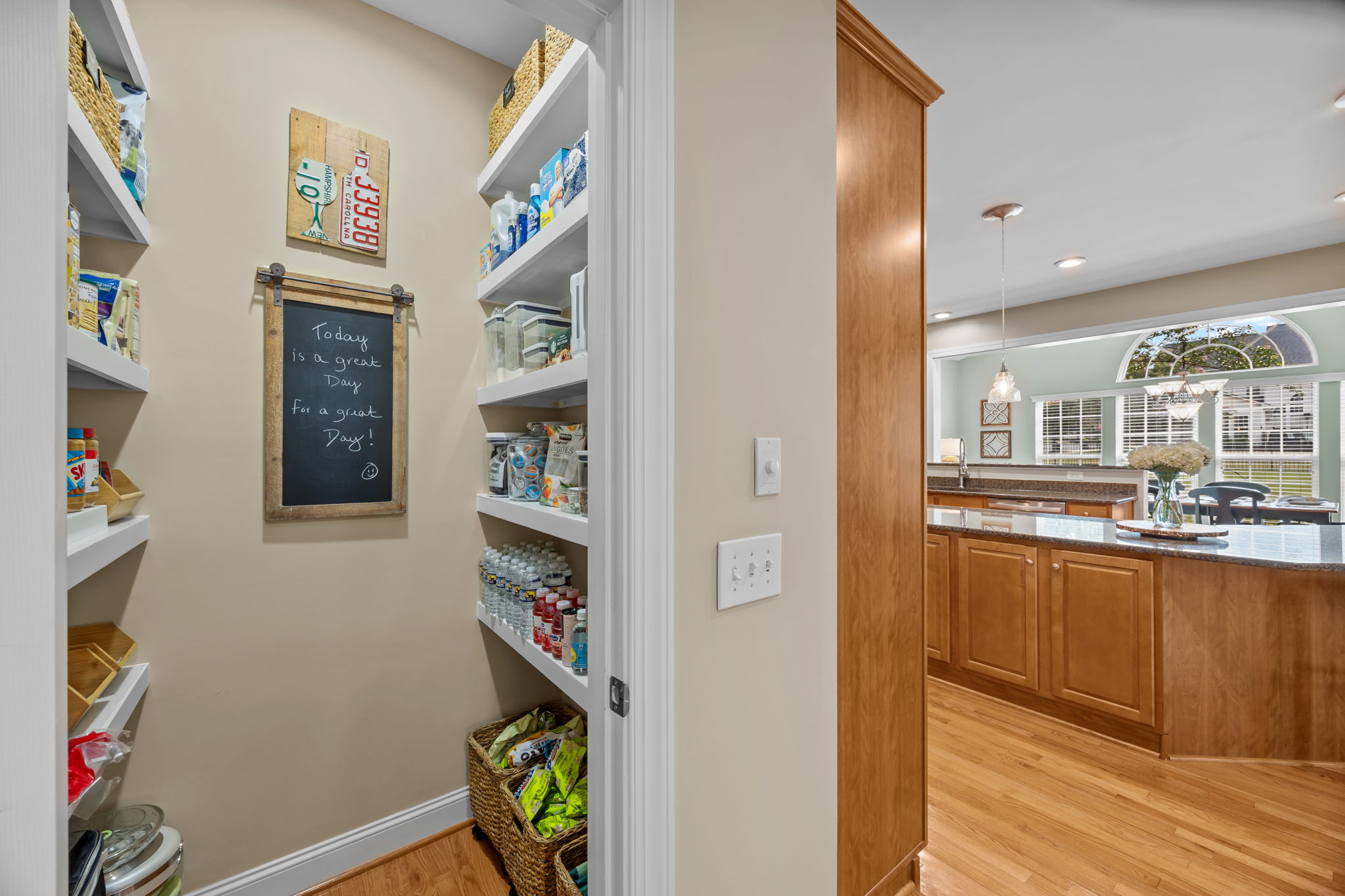 Walk-in lighted pantry with wood shelving