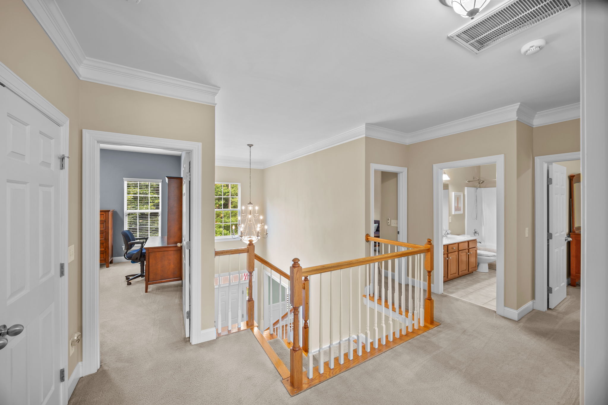 Airy and bright second floor landing with crown molding