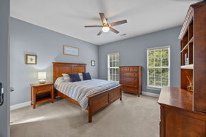 Bedroom 1 with ceiling fan and ensuite bath