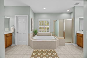 Primary bath with split vanities and plantation shutters